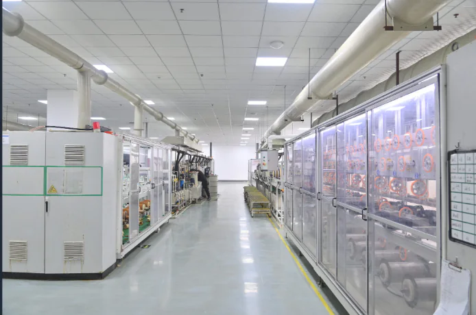 Production workshop in Jiading, Shanghai, with control cabinets on one side and enclosed diamond wire machines on the other